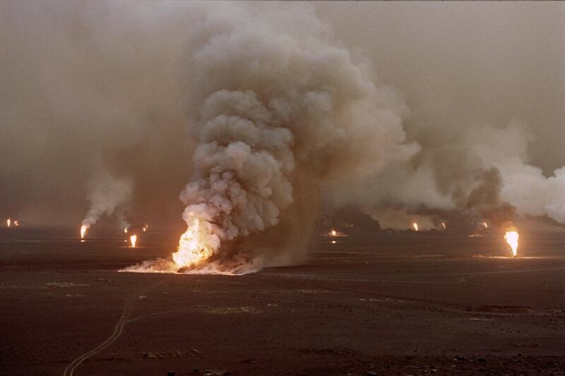 Several blown-out wells damaged by retreating Iraqi soldiers in Al-Ahmadi oil field  burn on April 1, 1991 in southern Kuwait. - In 1991, Iraqi troops retreating after a seven-month occupation, smashed and torched 727 wells, badly polluting the atmosphere and creating crude oil lakes. In addition, up to eight billion barrels of oil were split into the sea by Iraqi forces damaging marine life and coastal areas up to 400 kilometres (250 miles) away. Kuwait will seek more than 16 billion dollars compensation for environment destruction brought by Iraq during the 1991 Gulf War, Kuwaiti newspaper Al-Anba said December 7, 1998. (Photo by Pascal GUYOT / AFP)