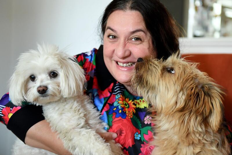 Varga poses with her dogs at her workshop in Budapest. AFP