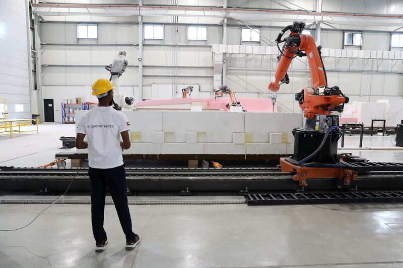 A robot prepares the moulding of a boat at the new shipyard. Pawan Singh / The National