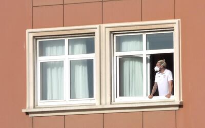 epa08559822 Spanish Second Division's CF Fuenlabrada team player Chico Flores looks from his room's window at the hotel where the team is confined in A Coruna, northwestern Spain, 22 July 2020. Six members of the team tested positive for COVID-19.  EPA/CABALAR