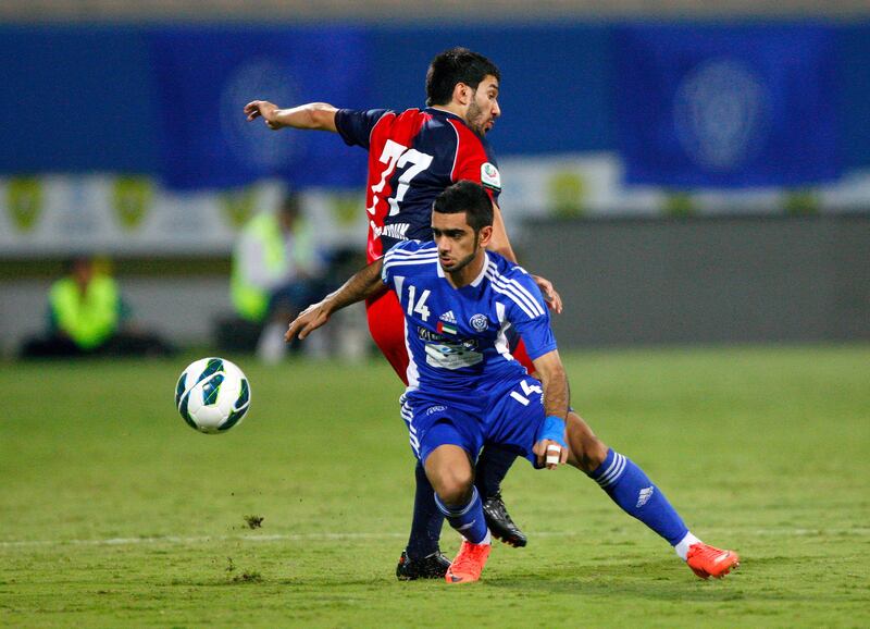 Humaid Ahmed of Al Nasr holds off Hassan Maatouk of Al Shaab during the Etisalat Pro League match between Al Nasr and Al Shaab at Zabeel Stadium, Dubai on the 3rd November 2012. Credit: Jake Badger for The National