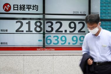 A man walks past a stock market indicator board in Tokyo, Japan. Experts say entire stock markets can be swayed by emotional extremes. EPA