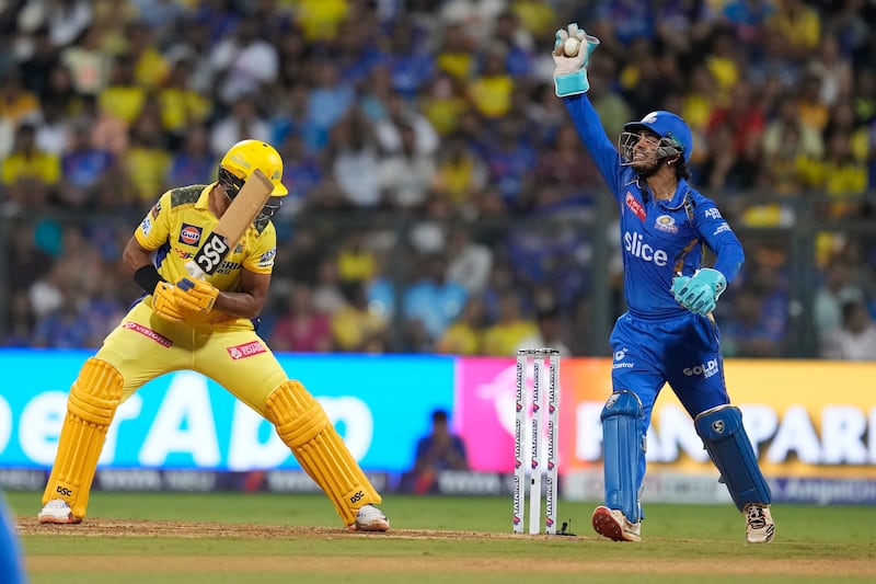 Mumbai Indians' Ishan Kishan, right, appeals successfully for the wicket of Chennai Super Kings' Rachin Ravindra, left, who made 21 runs off 16 balls. AP 