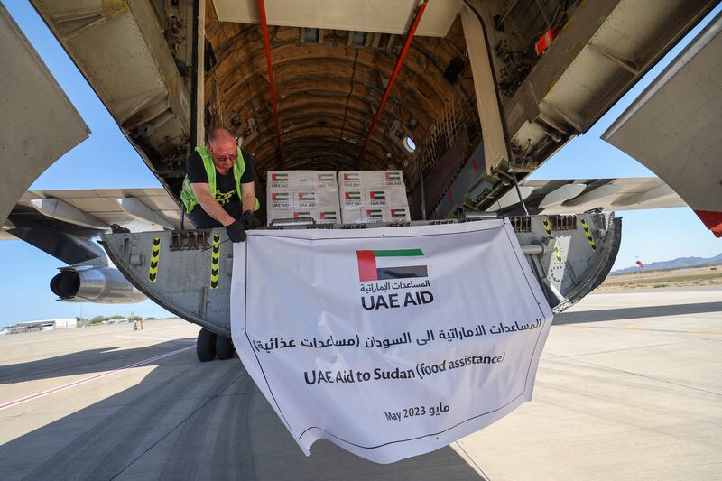 Members of staff offload aid supplies provided by the World Health Organisation and UAE Aid from a plane that arrived from the Emirates at Port Sudan on May 5. AFP