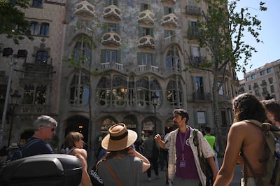 A tour guide addresses a group in front of Catalan architect Antoni Gaudi's Casa Batllo in Barcelona. AFP
