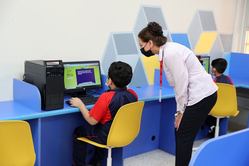 A Year 4 student is helped by a teacher at Apple International Community School in Karama, Dubai. All pictures by  Pawan Singh /The National