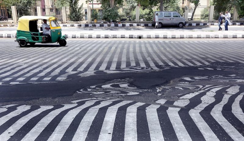 In the capital, New Delhi, road markings were beginning to distort  as the asphalt started to melt in the high temperature. Harish Tayagi  / EPA