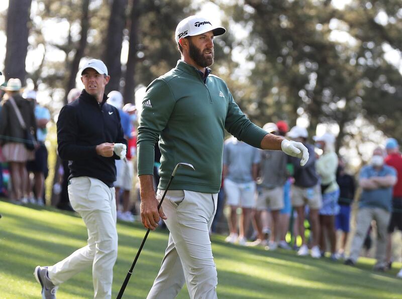 Defending Masters champion Dustin Johnson, right, and Rory McIlroy walk the fourth fairway  during their practice round for the Masters at Augusta National Golf Club. AP