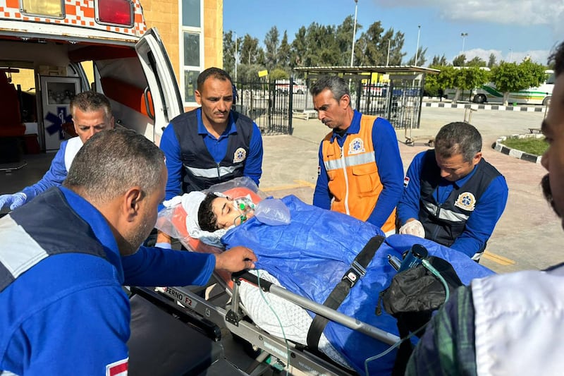 Egyptian paramedics receive an injured Palestinian evacuated from Gaza through the Rafah crossing. AFP