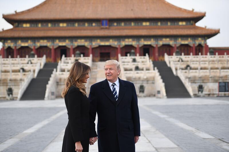 US President Donald Trump holds hands with first lady Melania Trump in the Forbidden City in Beijing. Jim Watson / AFP Photo