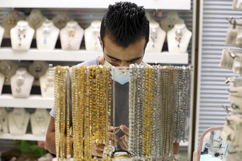 Dubai, United Arab Emirates - N/A. News. Coronavirus/Covid-19. A man makes jewellery at the Waterfront Market in Deira. Thursday, September 10th, 2020. Dubai. Chris Whiteoak / The National