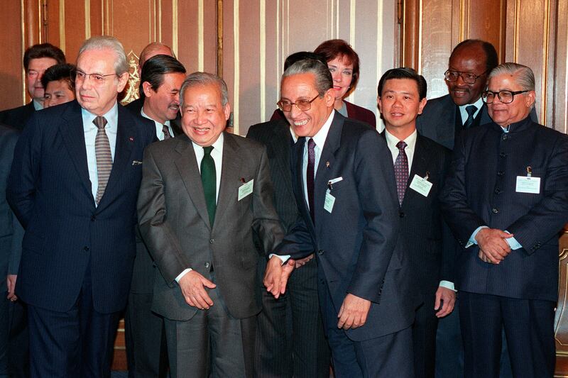 Then UN secretary general Javier Perez de Cuellar, front left, Cambodia's Prince Norodom Sihanouk, front second left, and then Philippines' foreign secretary Raul Manglapus, front , centre, with other delegates to the Cambodian Peace Conference in Paris in 1991 AFP