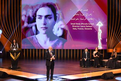 Director of Italian culture in Egypt, David Scalmany receives The Silver Pyramid on behalf of Laura Samani during the closing ceremony of the 43rd Cairo International Film Festival. AFP