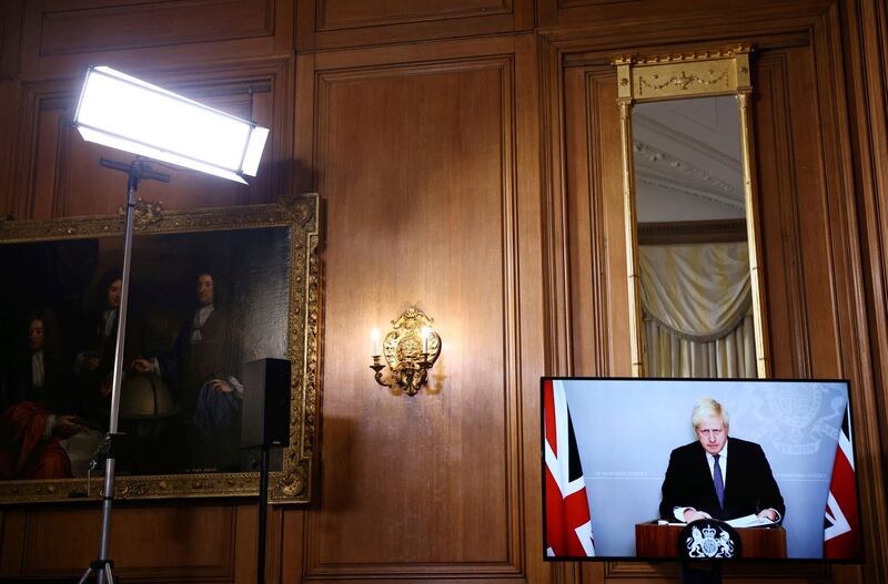 Britain's Prime Minister Boris Johnson appears on screen during a coronavirus news conference giving an update about Covid-19 pandemic, at Downing Street in London. AP