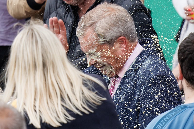 Mr Farage has a milkshake hurled at him during a campaign event in Clacton-on-Sea. EPA