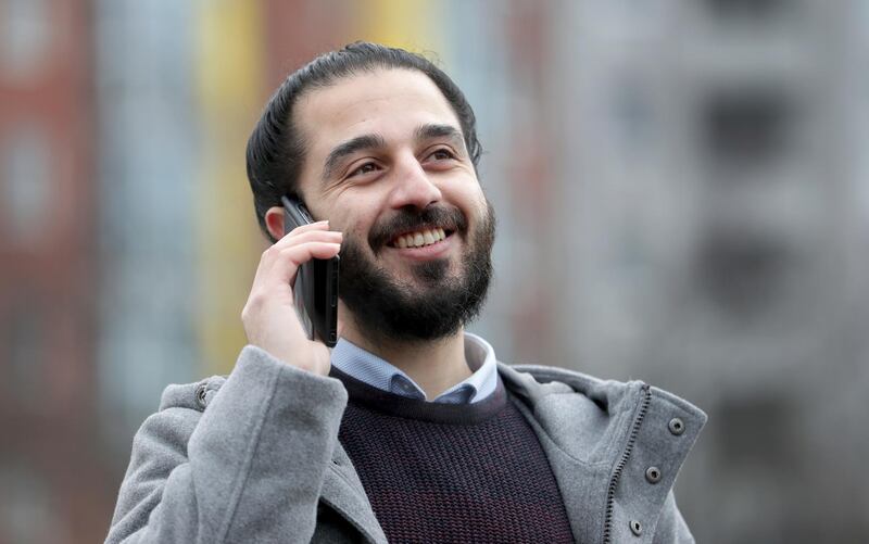 Tareq Alaows, who is running to become a lawmaker at the German parliament Bundestag speaks on a cell phone, during an interview with the Associated Press in Berlin, Germany, Wednesday, Feb. 3, 2021. Tareq Alaows fled the civil war in Syria in 2015, crossed the Mediterranean on a flimsy rubber boat and tracked up the Balkans, like over a million migrants looking for a save haven in Germany. Five years on, the 31-year-old Syrian has received asylum, speaks fluent German, has a job, applied for citizenship and launched his campaign to run for federal elections in Germany on Sept. 26, 2021. (AP Photo/Michael Sohn)