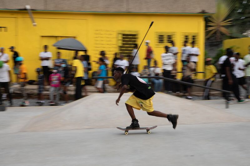 A boy uses a skateboard during the opening of the Freedom Skate Park in Accra, Ghana, on December 15, 2021.  - The Freedom Skate Park is the first skate park and a recreational center created by the youth in Ghana.  (Photo by Nipah Dennis  /  AFP)