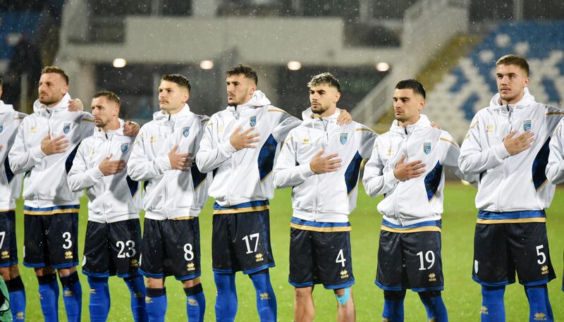 Kosovo players line up during the national anthems before the match. Reuters