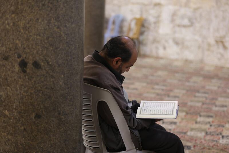 Palestinian reads verses from the Koran  during the Islamic holy month of Ramadan, in the West Bank city of Nablus.  EPA