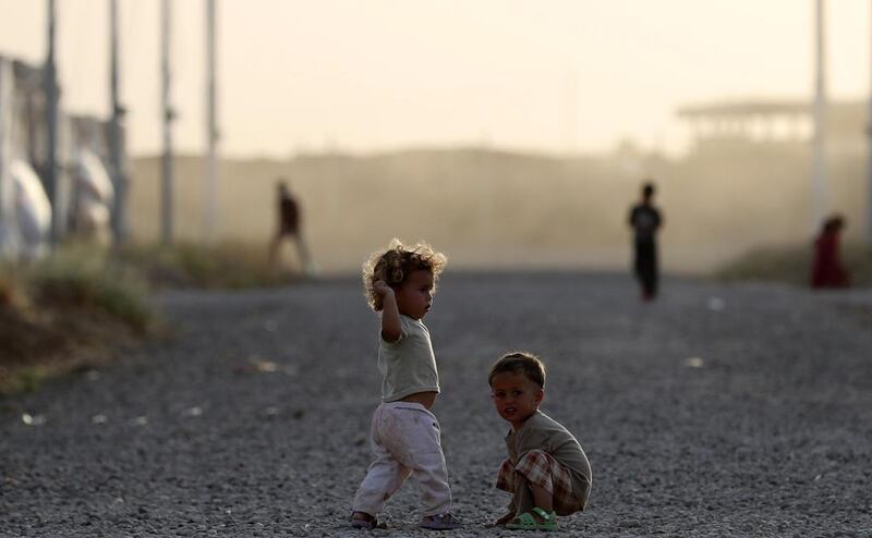 Iraqi refugee children play outside on the first day of Ramadan at Al Khazir camp in northern Iraq. Karim Sahib / AFP Photo