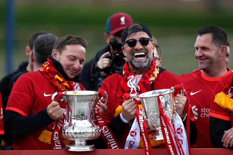 Pep Lijnders and Jurgen Klopp with the FA Cup and the League Cup trophies. Getty