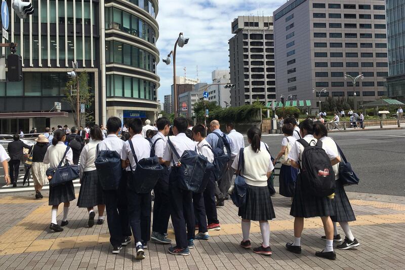 Japanese schoolchildren cross a street in Tokyo on September 1, 2017.
As Japan's schools reopened Friday after summer holidays, a day when suicides among young people spike, celebrities reached out to at-risk kids and one Tokyo zoo offered refuge to petrified pupils in a bid to tackle the mental health crisis. For some schoolkids, the thought of returning to school sends their stress levels soaring, as they battle fears ranging from schoolyard bullies to doing poorly on exams.
 / AFP PHOTO / Behrouz MEHRI / TO GO WITH Japan-social-suicide, FOCUS by Karyn NISHIMURA-POUPEE