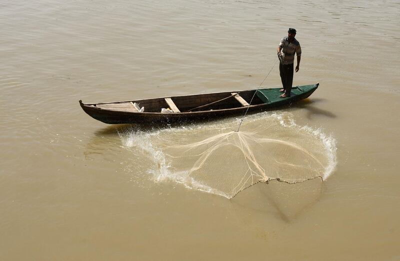 A fisherman throws his net in the Euphrates river, in Iraq's Shatrah district of the southern Dhi Qar province.  AFP