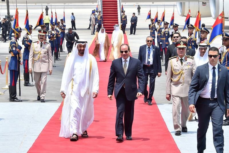 Egyptian President Abdel Fattah al-Sisi walks with Abu Dhabi's Crown Prince Sheikh Mohammed bin Zayed al-Nahyan on his arrival at Cairo's Airport, Egypt. Reuters