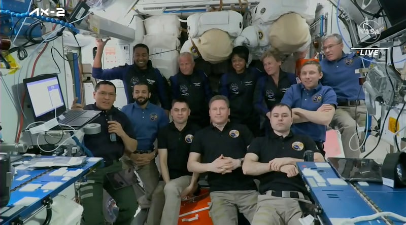 Top row from left, Ali Al Qarni, John Shoffner, Rayyanah Barnawi and Peggy Whitson, pose for a picture with current residents of the International Space Station. The space station has rolled out the welcome mat for the two Saudi visitors, including the kingdom's first female astronaut.  AP