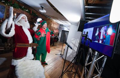 NEWQUAY, UNITED KINGDOM - NOVEMBER 27: Santa Claus and his elf Pipkin talk to children on Zoom on November 27, 2020 in Newquay, England. A new partnership between Santa Claus and Children's Hospice South West sees Santa meeting with children right across the country, safely in the comfort of their own homes via Zoom. For every session booked a 10% donation will go to Children's Hospice South West, supporting care for children with life-limiting conditions and their families. (Photo by Finnbarr Webster/Getty Images) *** BESTPIX ***