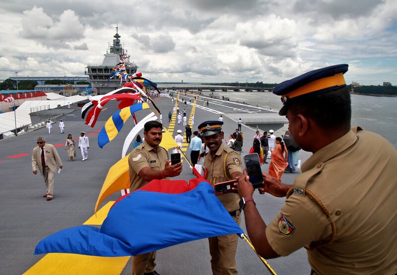 Police officers take selfies on the flight deck of India's first home-built aircraft carrier, the 'INS Vikrant' after its commissioning ceremony, in Kochi. Reuters