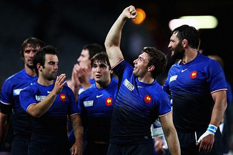 Clerc, raising his arm in triumph at full time, and the rest of France celebrate their 19-12 win to set up a semi-final tie against Wales next weekend.

Phil Walter / Getty Images