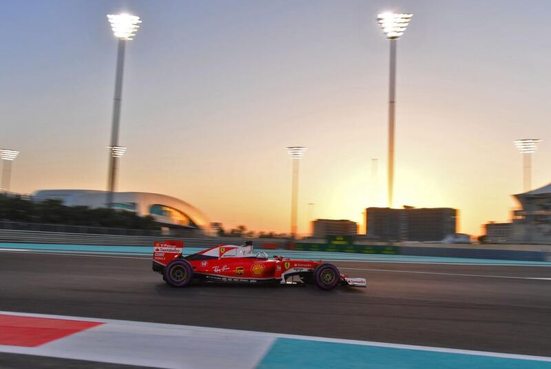 Sebastian Vettel drives his Ferrari as the sun sets. Andrej Isakovic / AFP Photo