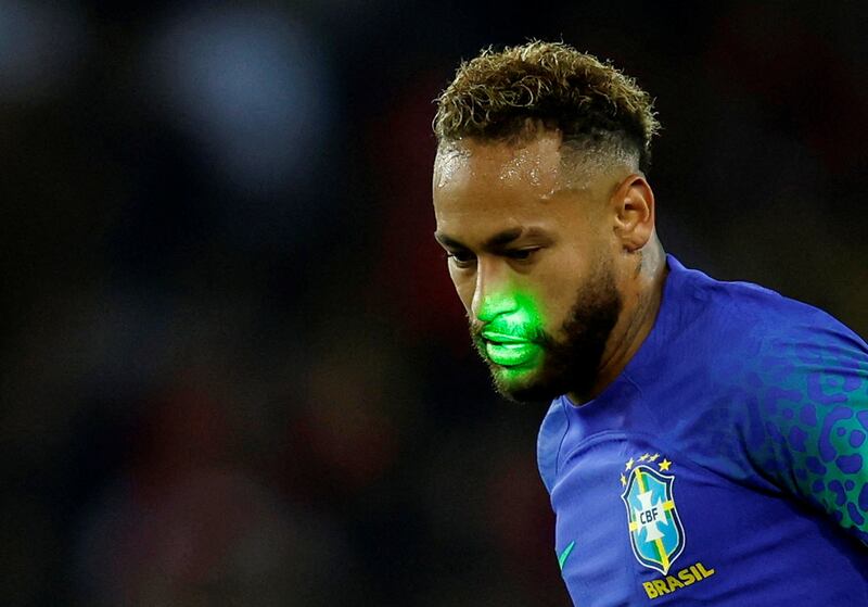 Brazil's Neymar reacts as a laser is shone onto his face. Reuters