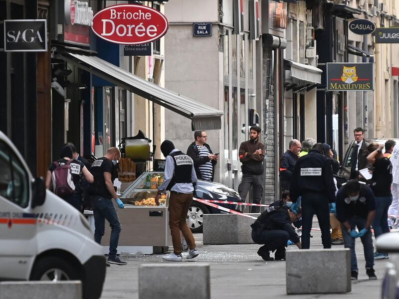 French police search for evidence in front the Brioche Doree cafe after a suspected package bomb blast along a pedestrian street in the heart of Lyon. AFP