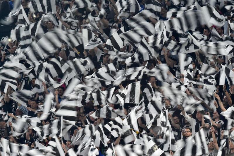 Juventus fans celebrate a goal by Paulo Dybala. Giuseppe Cacace / AFP
