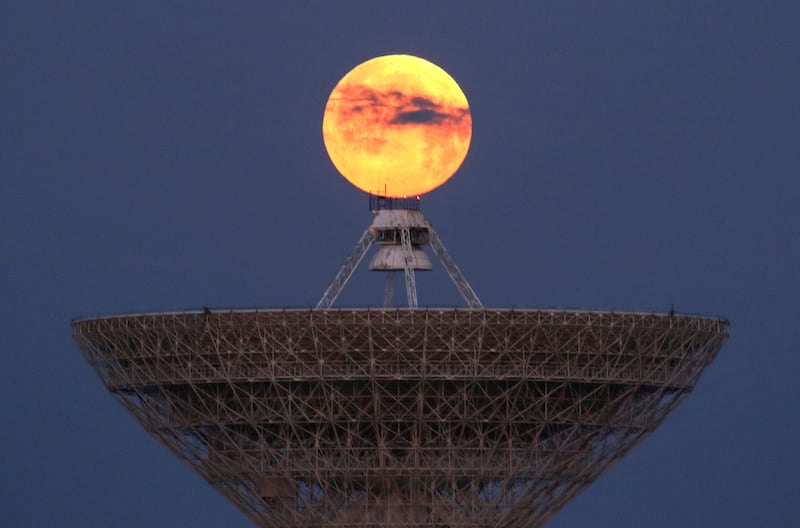 The Moon is seen through clouds behind the radio telescope RT-70 in the village of Molochnoye, Crimea. Reuters