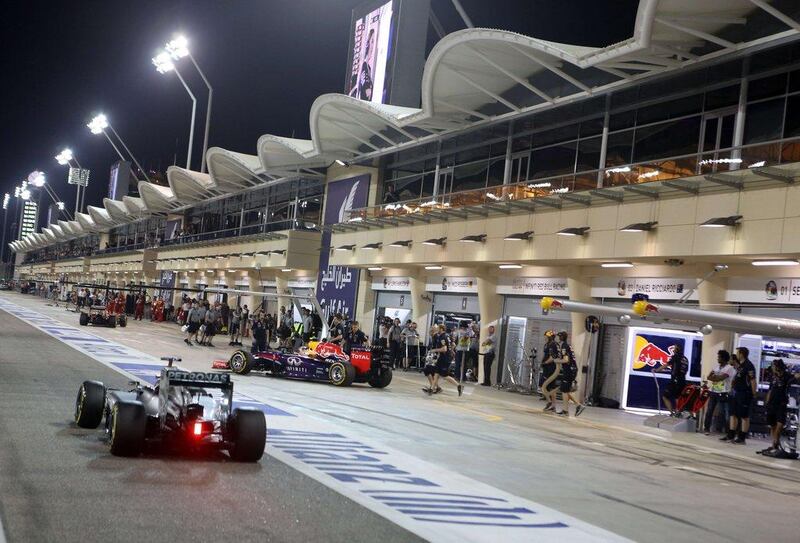 F1 cars are seen at the pit during the Formula One Bahrain Grand Prix at the Sakhir Circuit in Manama, Bahrain on Saturday. Patrick Baz / AFP / April 5, 2014