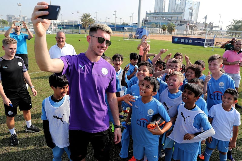 ABU DHABI, UNITED ARAB EMIRATES , Nov 30 – 2019 :- Aymeric Laporte, French footballer taking selfie with the students of Manchester City football school Abu Dhabi at the Zayed Sports city in Abu Dhabi. ( Pawan Singh / The National )  For Sports. Story by Jon Turner 
