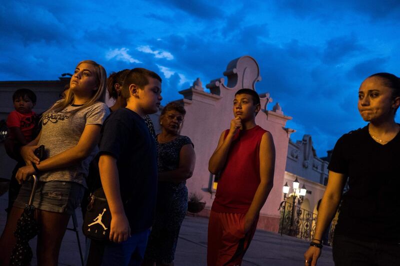 El Paso residents stand outside after a vigil ceremony at Saint Pius X Church. AFP