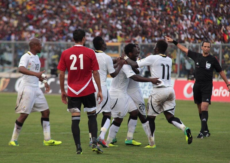 Ghana celebrate after their first goal, a fifth-minute penalty by Al Ain's Asamoah Gyan, in Tuesday night's play-off win over Egypt. AP Photo