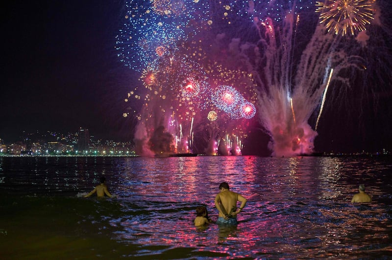 People enjoy the fireworks during the new year celebration on Copacabana beach in Rio de Janeiro, Brazil, on January 1, 2019.  AFP