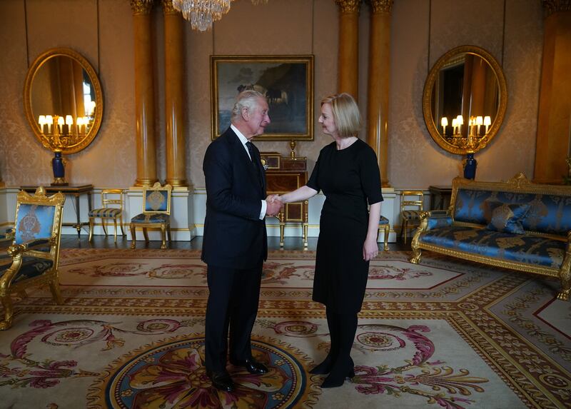 King Charles shakes hands with British Prime Minister Liz Truss during their first audience at Buckingham Palace