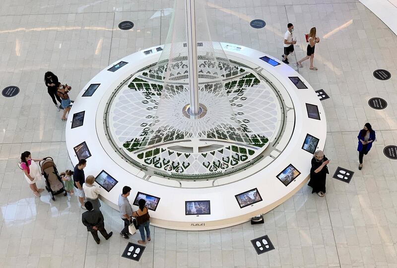 
DUBAI, UNITED ARAB EMIRATES , Sept 8 – 2020 :-  Visitors looking at the model of Dubai Creek Tower at Dubai Mall in Dubai. (Pawan Singh / The National) For Stock
