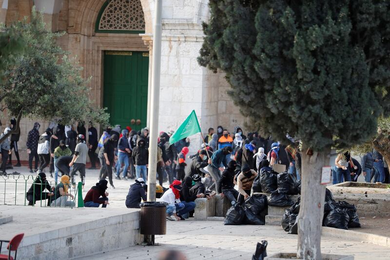Palestinians gather at the compound after violence broke out on Friday. AFP