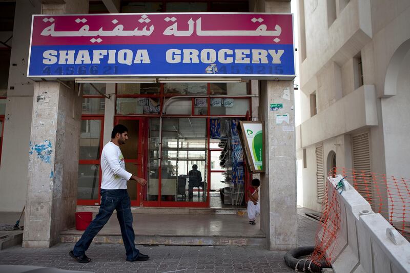 Abu Dhabi, United Arab Emirates, January 10, 2013: 
A man walks by the Malabar Grocery, a recently closed convenience store on Thursday, Jan. 10, 2013, in the city block between Airport and Muroor, and Delma and Mohamed Bin Khalifa streets in Abu Dhabi. 
Silvia Razgova/The National

