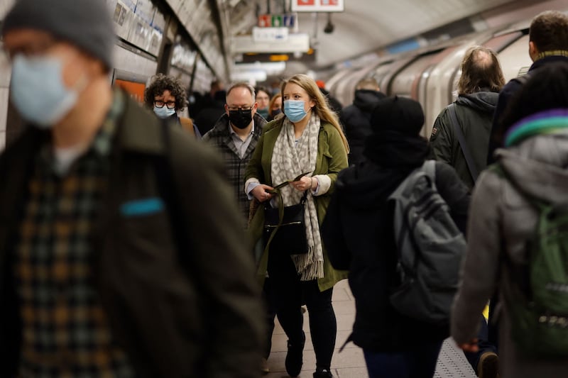 Commuters get off an underground train in London. Covid restrictions had initially been due to expire on March 24, but Mr Johnson says the 'encouraging' infection figures mean the restrictions can end a month early. AFP