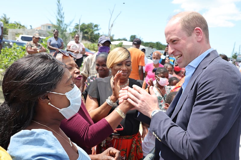 The Duke of Cambridge shakes hands with members of the public in Abaco, at a fish fry, a traditional Bahamian culinary gathering place.