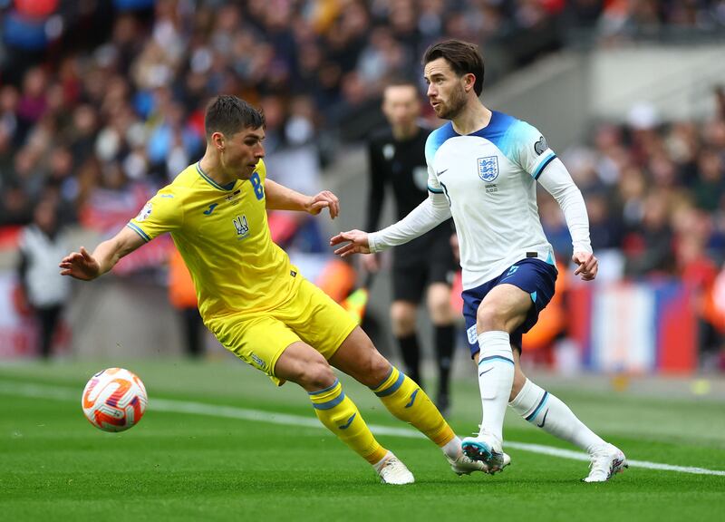 Ukraine's Ruslan Malinovskyi is beaten by England's Ben Chilwell. Reuters