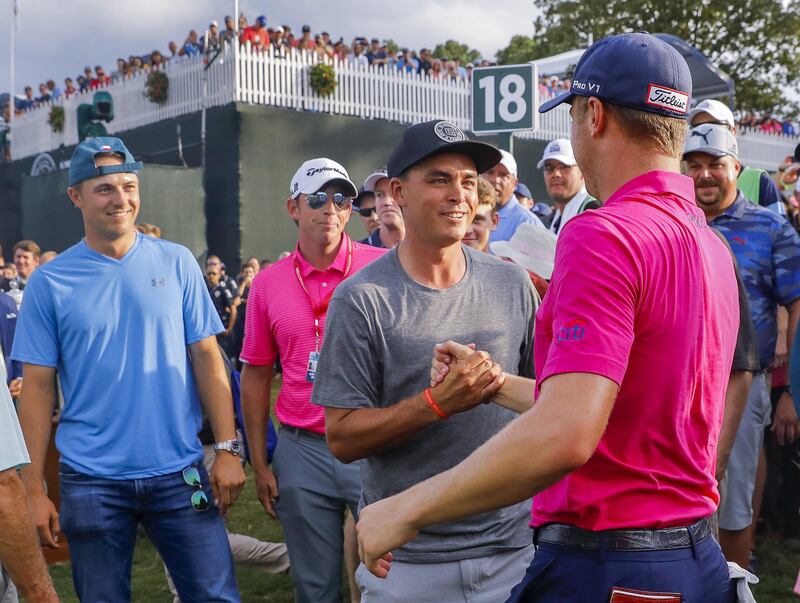 epa06143421 Justin Thomas (R) of the USA is greeted by Rickie Fowler (C) of the USA and Jordan Spieth (L) of the USA after walking off the 18th green during the final round of the 99th PGA Championship golf tournament at Quail Hollow Club in Charlotte, North Carolina, USA, 13 August 2017.  EPA/ERIK S. LESSER